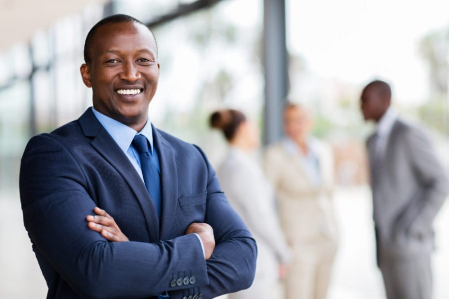 portrait of successful african office worker with arms crossed